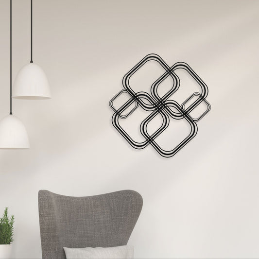 Decorative wall art with interlocking square shapes on a light wall.