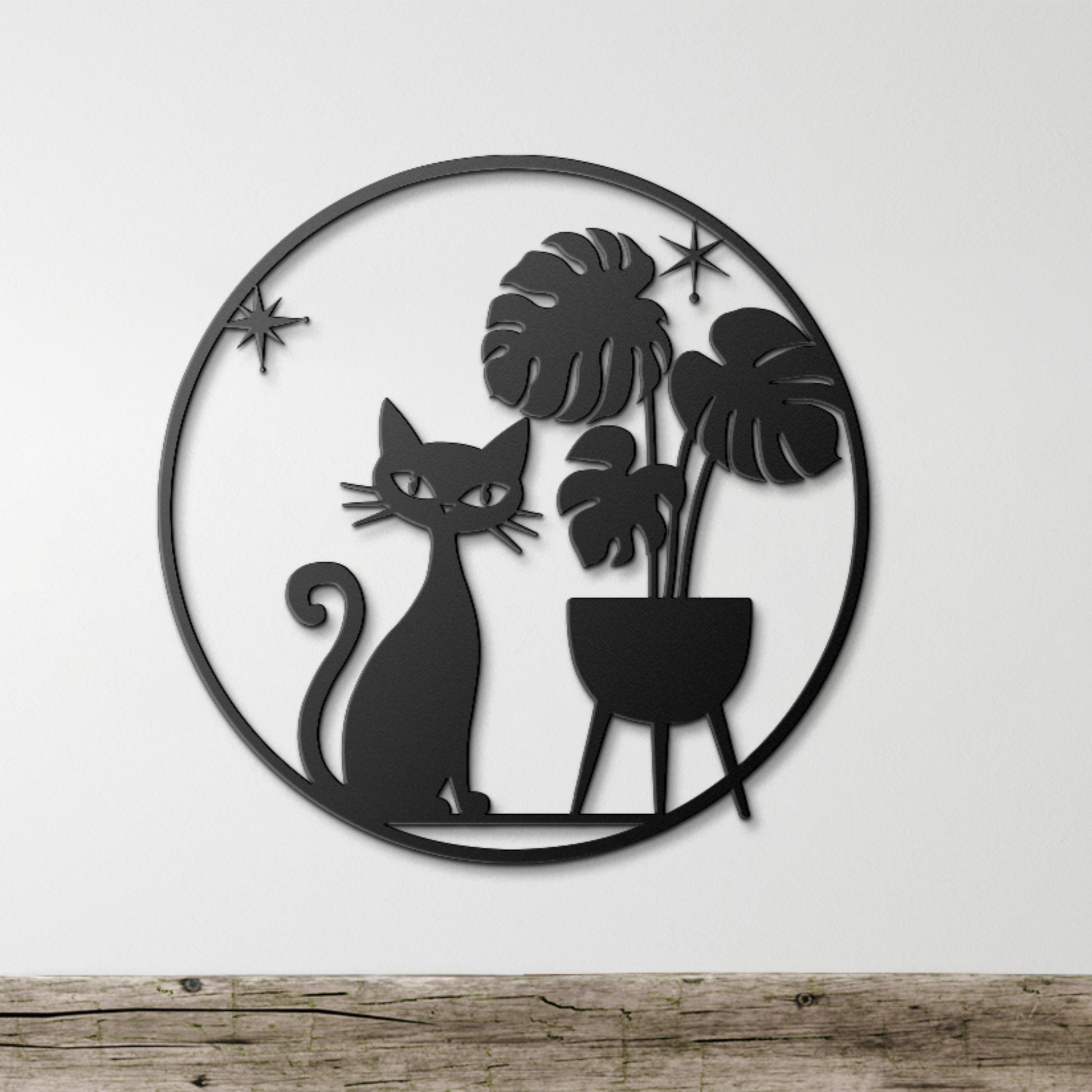 Black metal wall decor featuring cat and monstera leaves in retro style