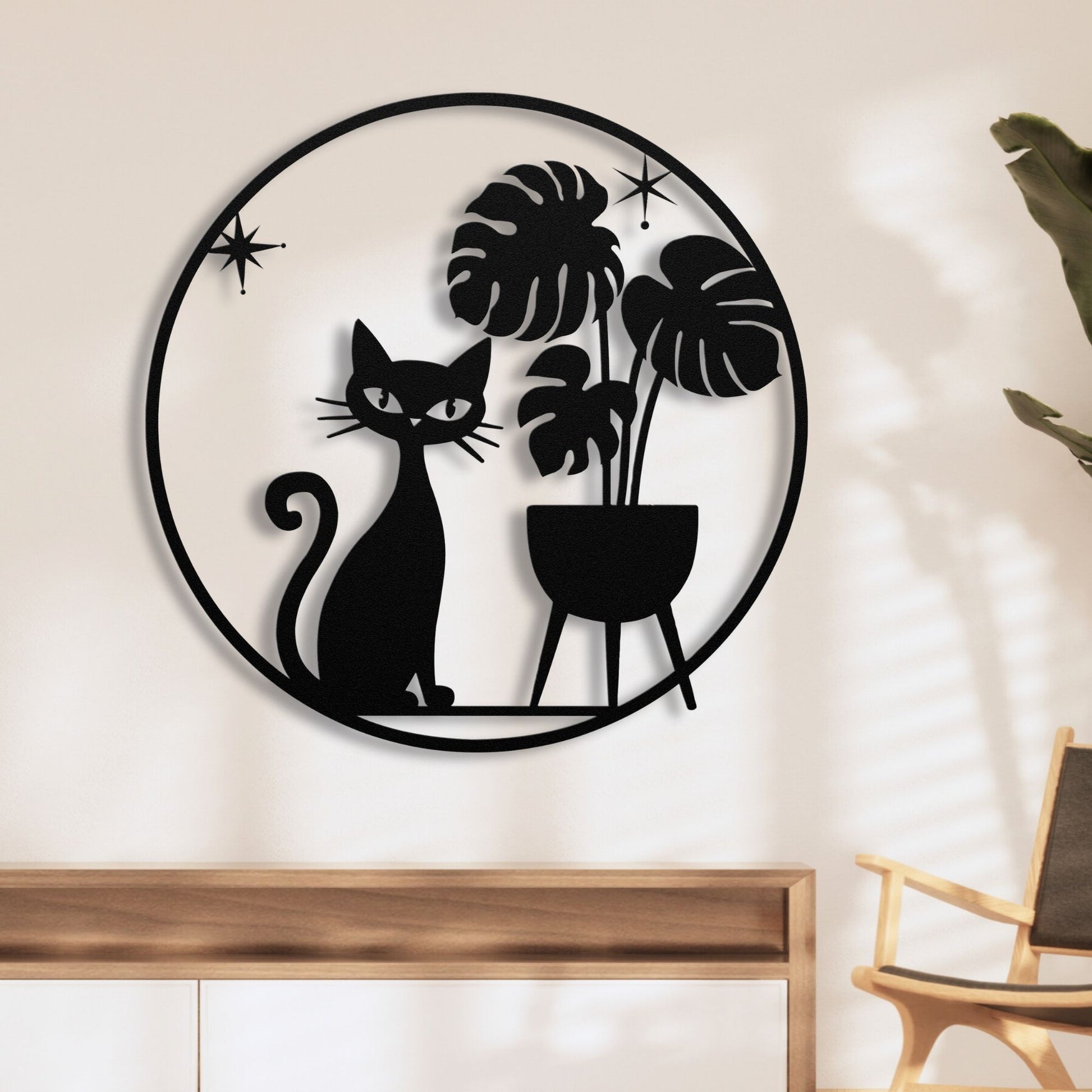 Mid-century modern wall art with cat and monstera plant in metal circle