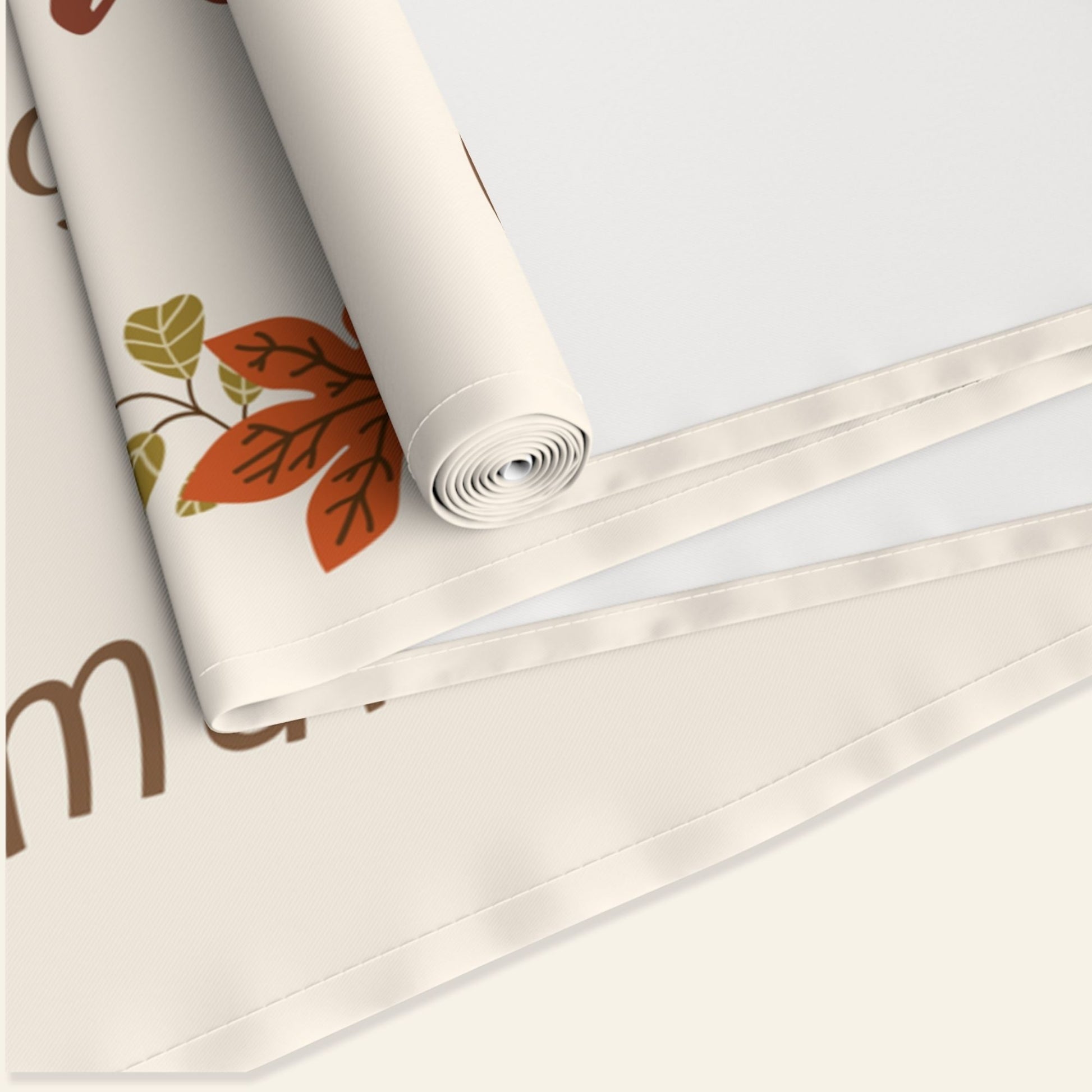 Roll of runner with autumn leaf design on a white background