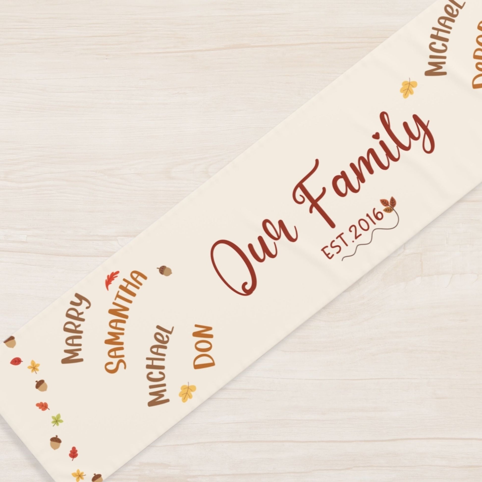 Personalized family name runner with autumn-themed design on a wooden surface