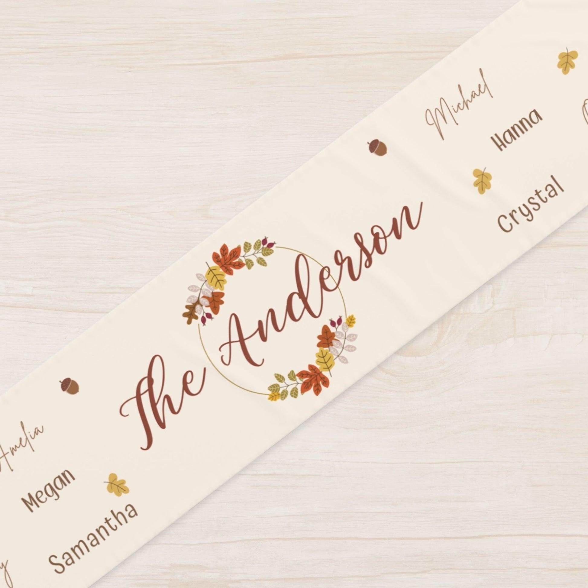 Personalized name runner with floral design on a wooden surface