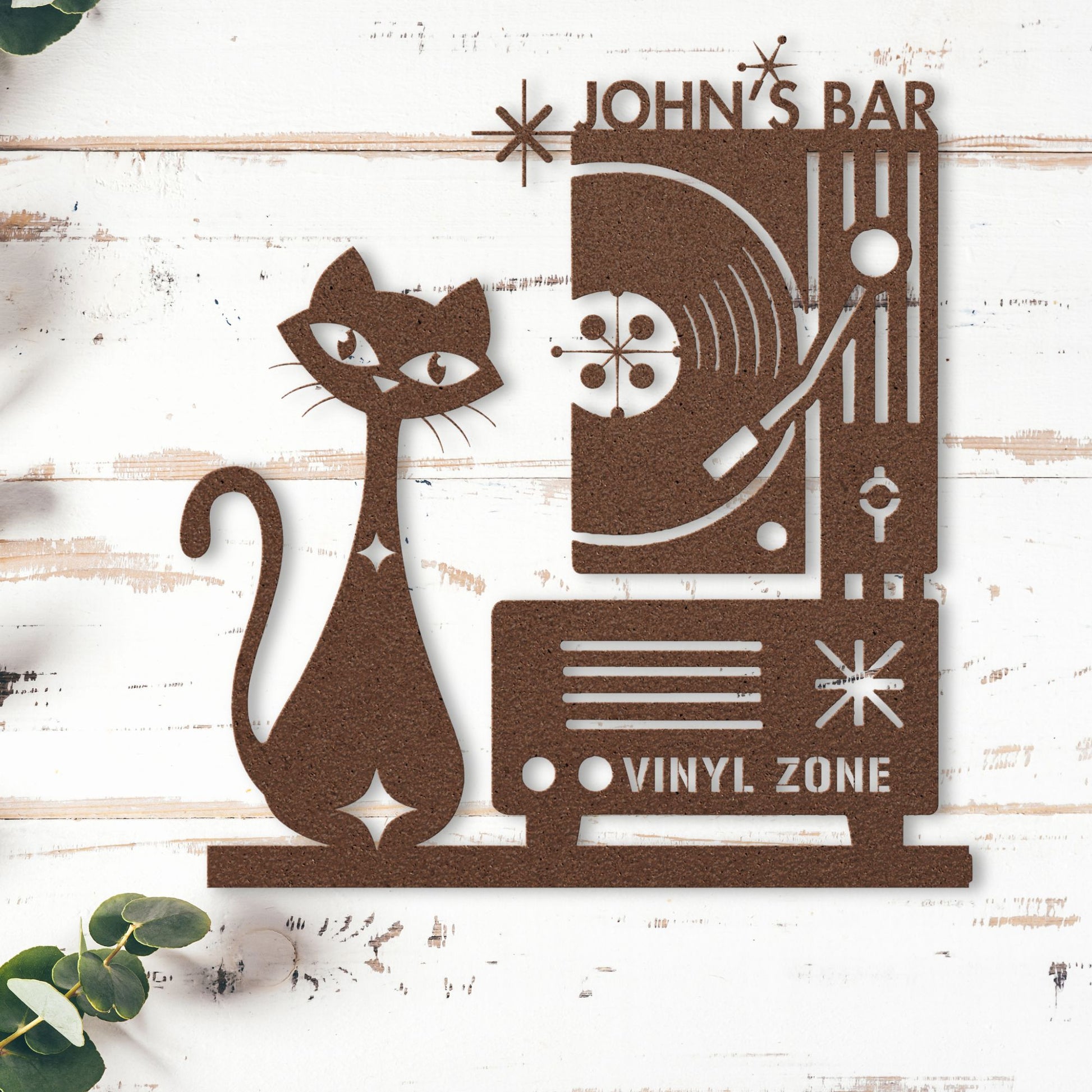 Decorative metal sign with a cat and vinyl record design on a wooden background.