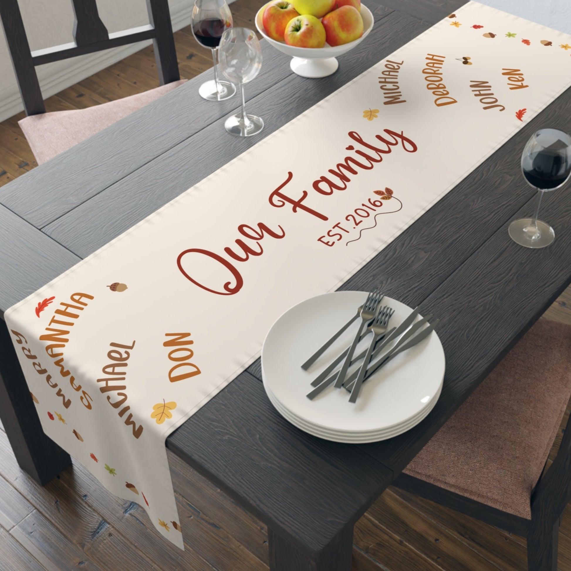 Dining table with a personalized table runner displaying family names and establishment year.
