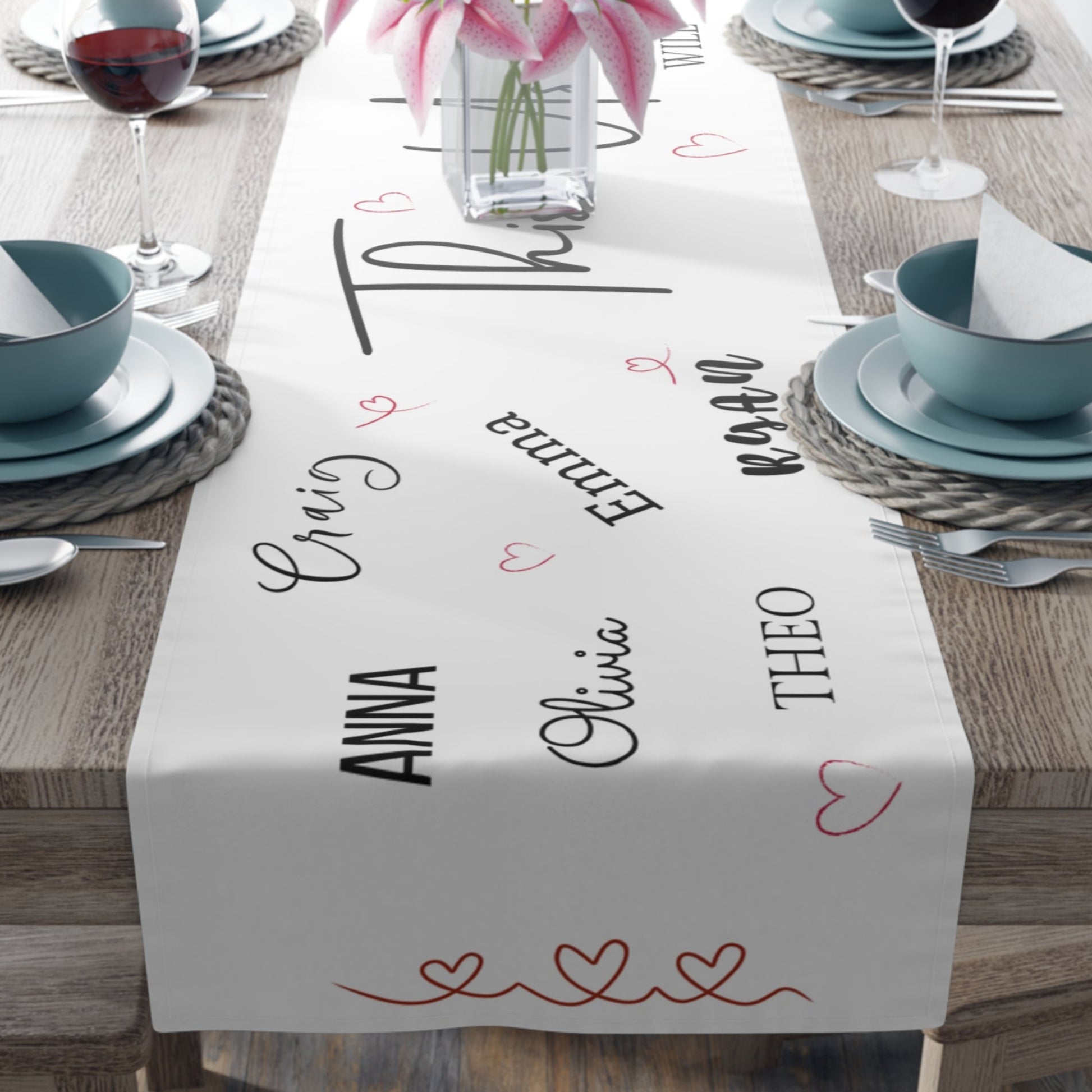 Personalized name table runner in white with elegant script text, perfect for weddings, family gatherings, and home décor