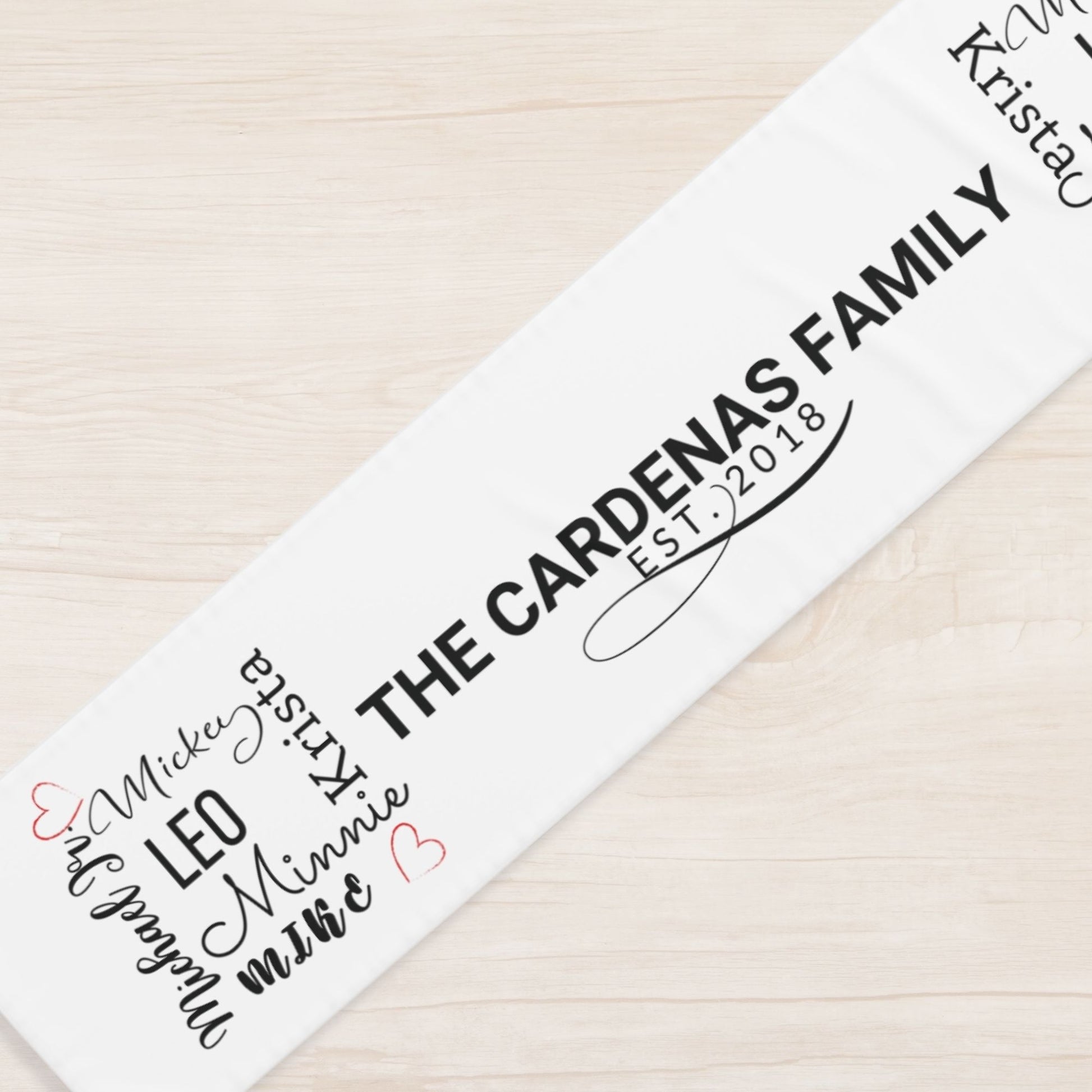 Personalized family name runner with children's names on a wooden surface