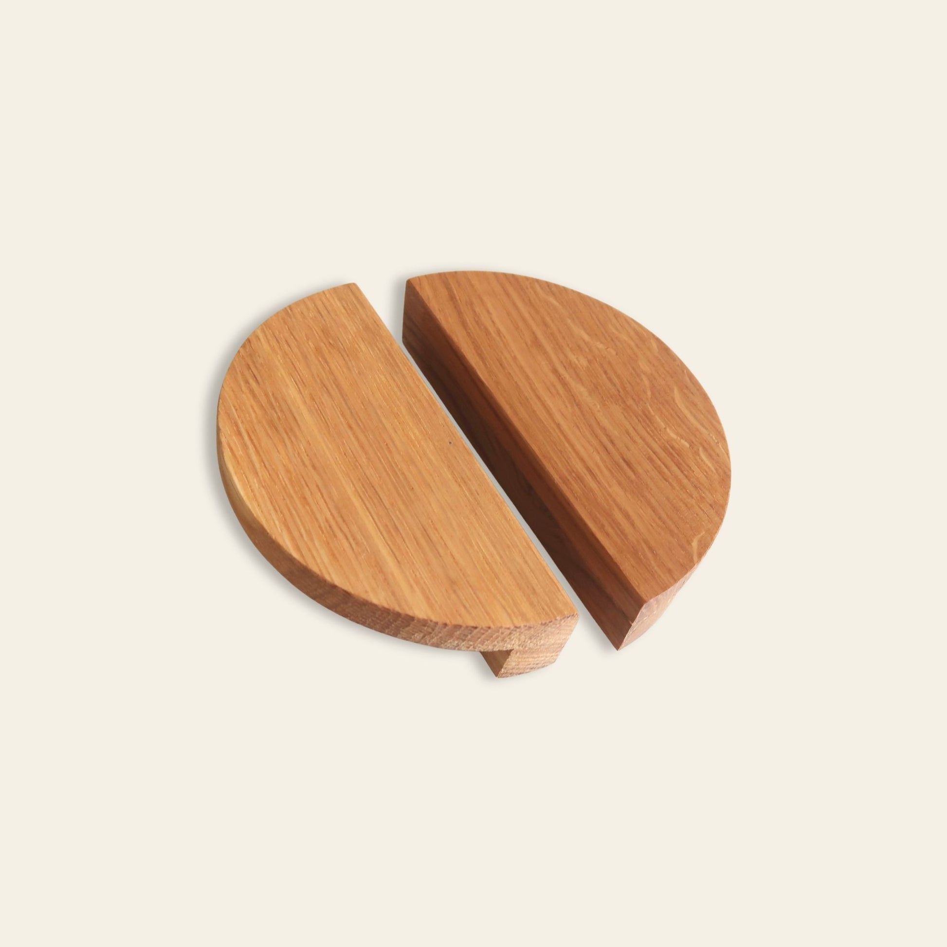 Half-moon oak cabinet handles with minimalist geometric design on light background