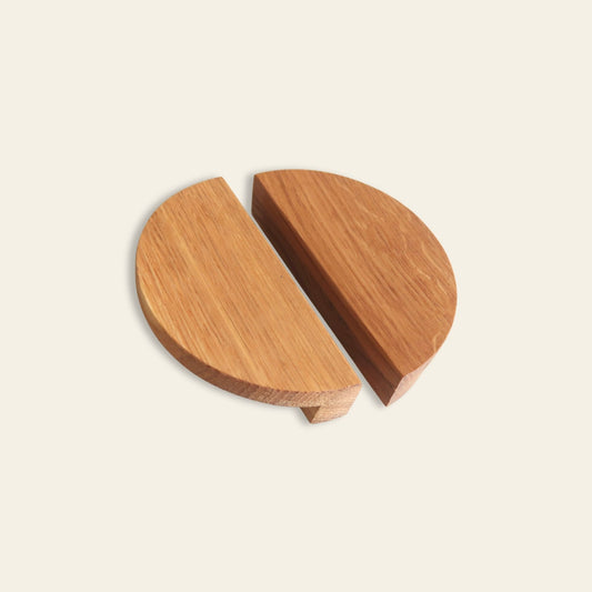 Half-moon oak cabinet handles with minimalist geometric design on light background