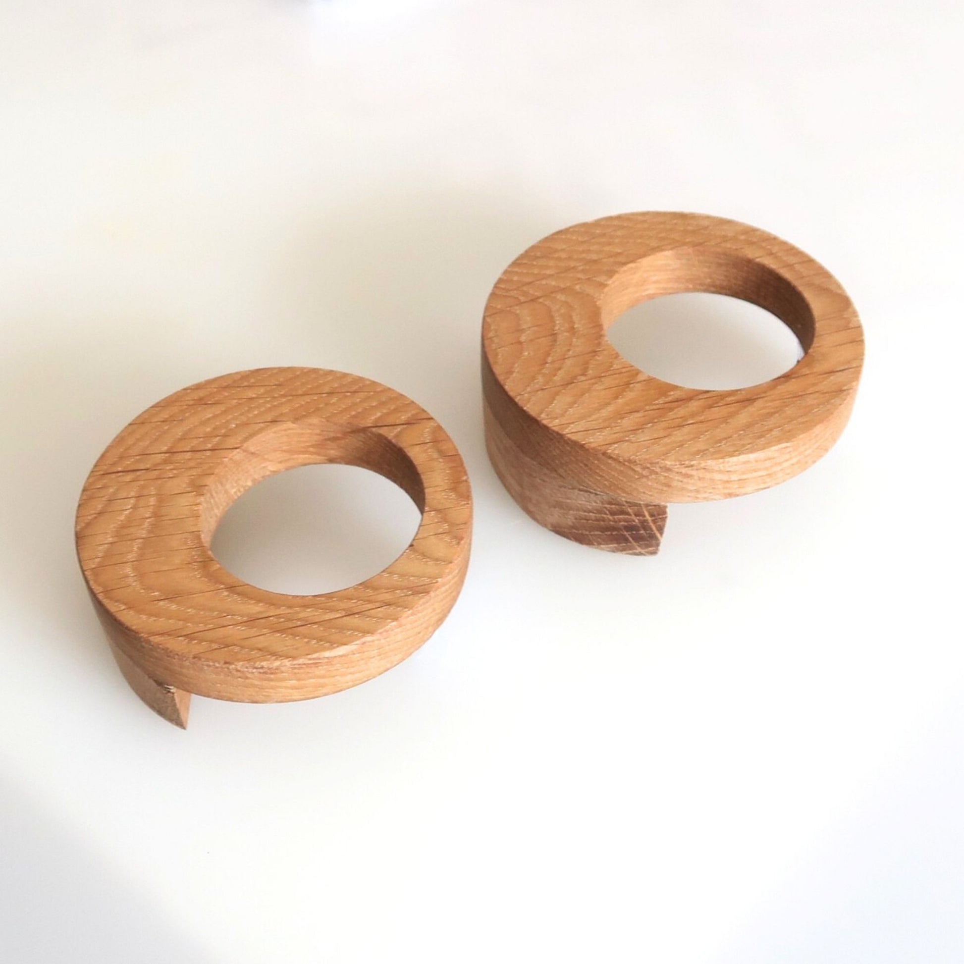 Two wooden drawer knobs on a white background