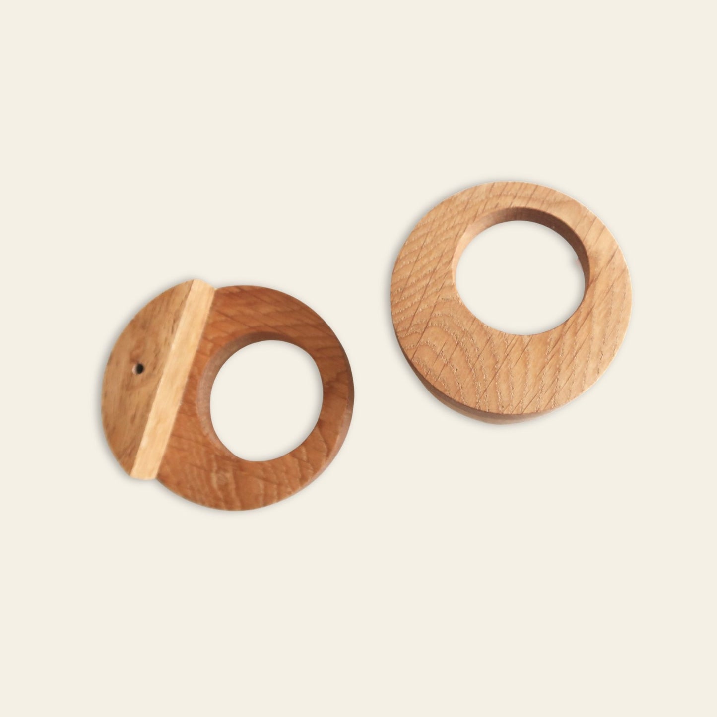 Two oak pulls on a beige background
