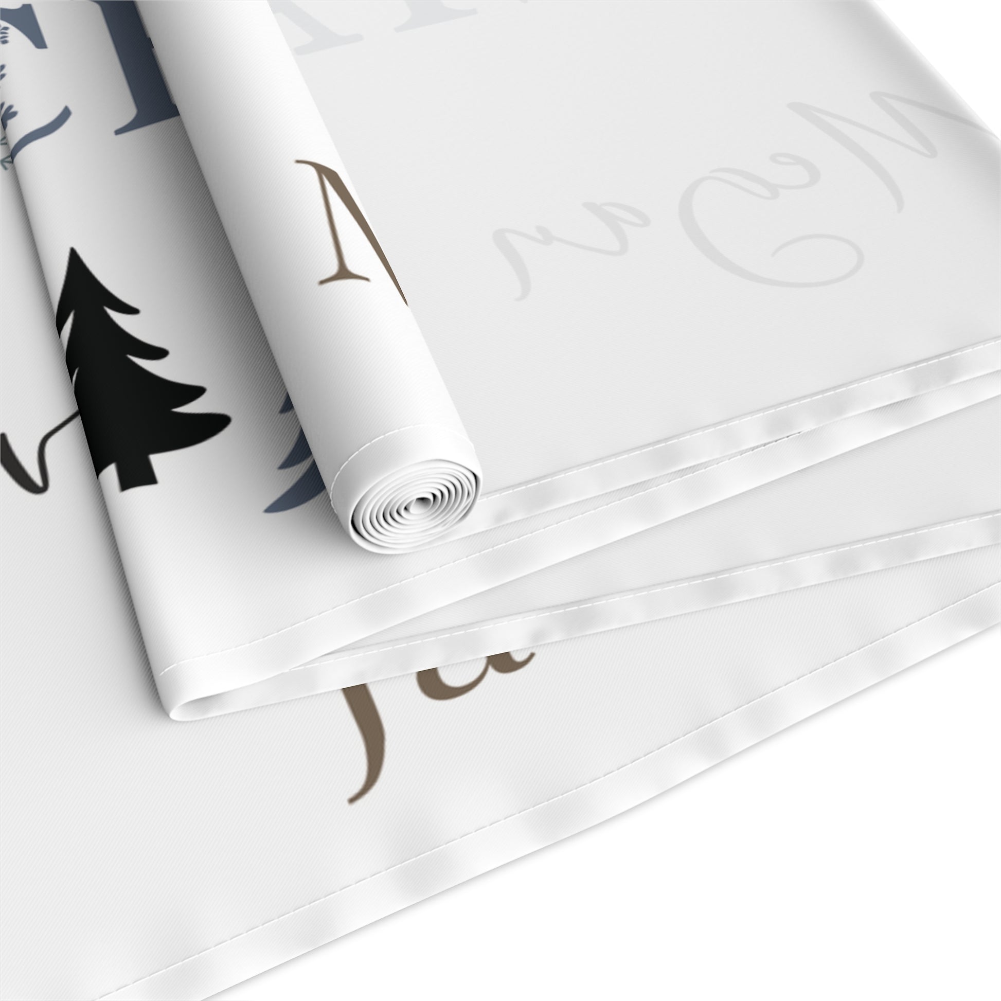 Roll of white runner with black and gold text and designs on a white background