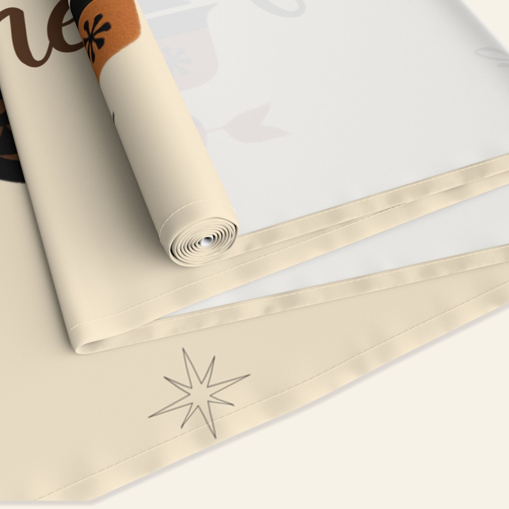 Roll of beige fabric with family name and Thanksgiving design
