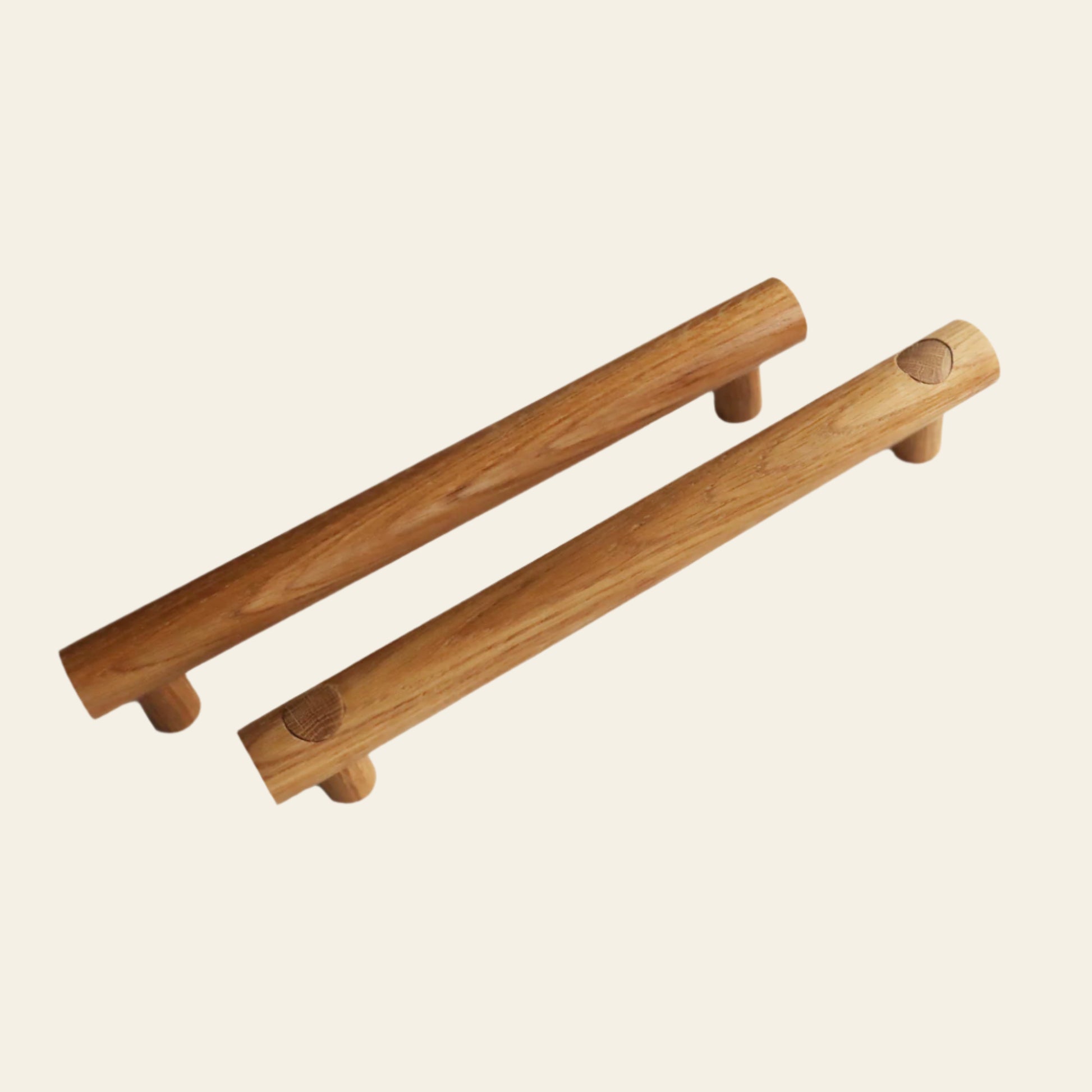 A wooden handle with a cylindrical shape and two shorter cylindrical stubs protruding from one side, against a white background.