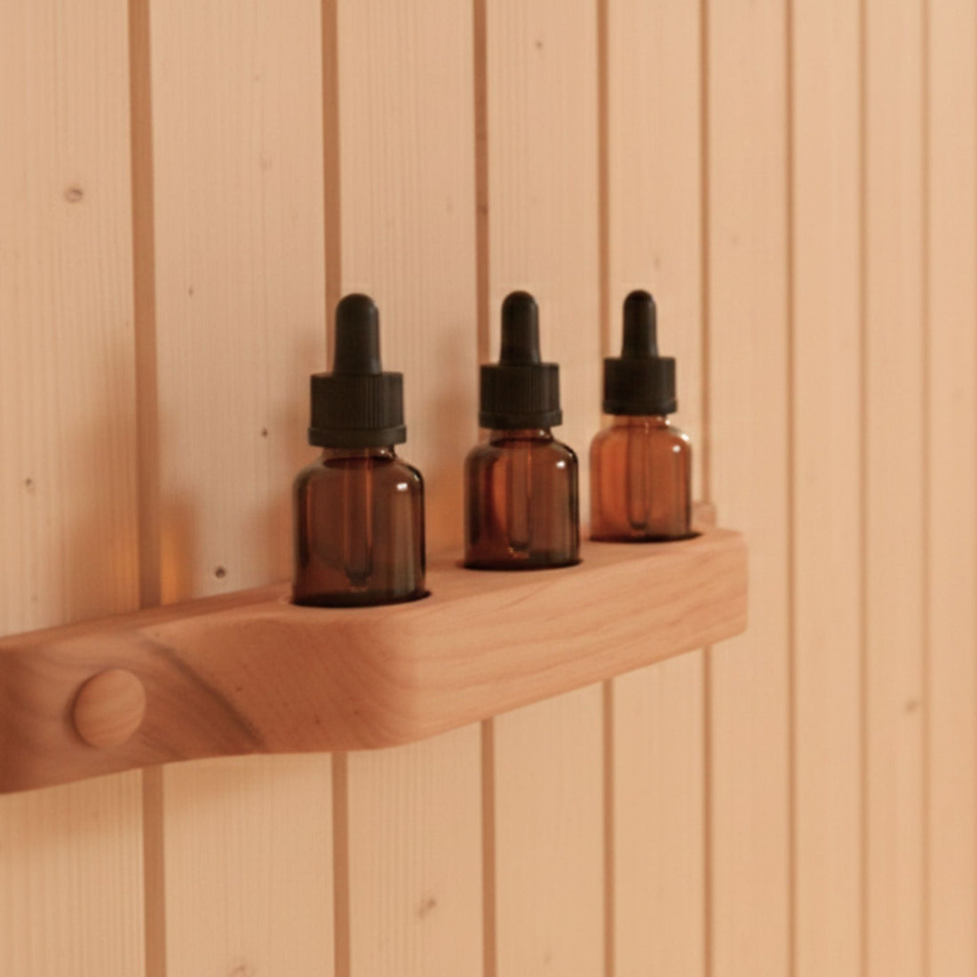 Alder wall shelf holding essential oil bottles in a wooden sauna interior