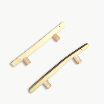 Two wooden door handles on a white background