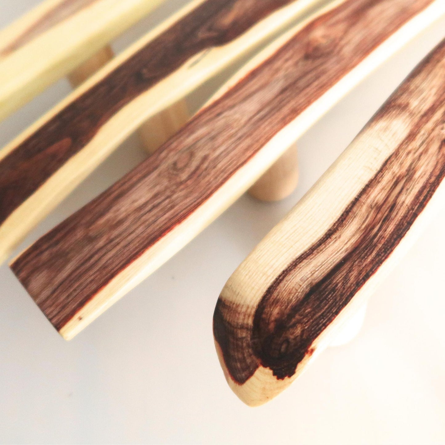 acacia handles with a natural wood grain pattern on a light background