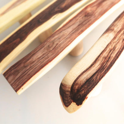 acacia handles with a natural wood grain pattern on a light background