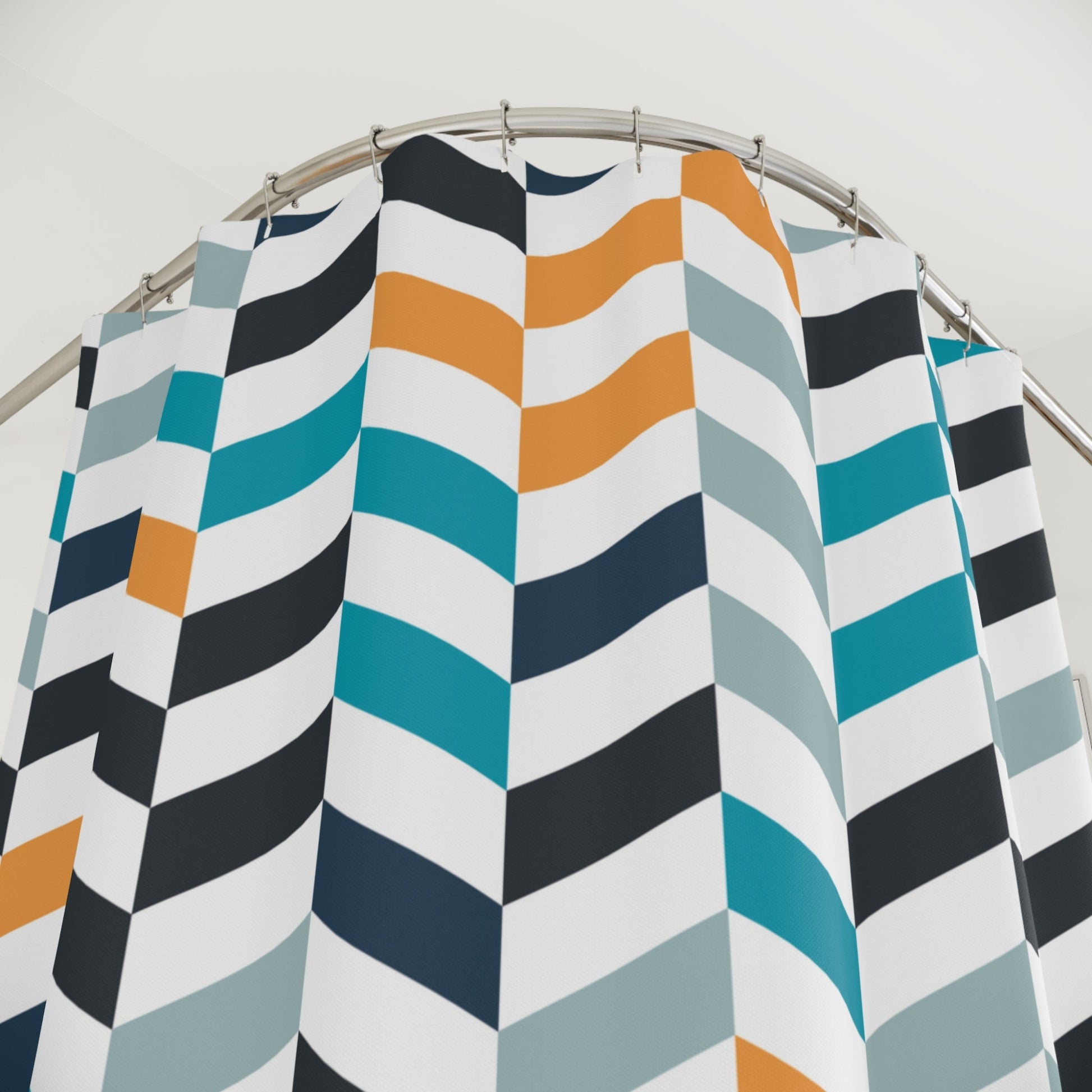 a colorful chevron shower curtain with shades of blue, orange, and gray. 