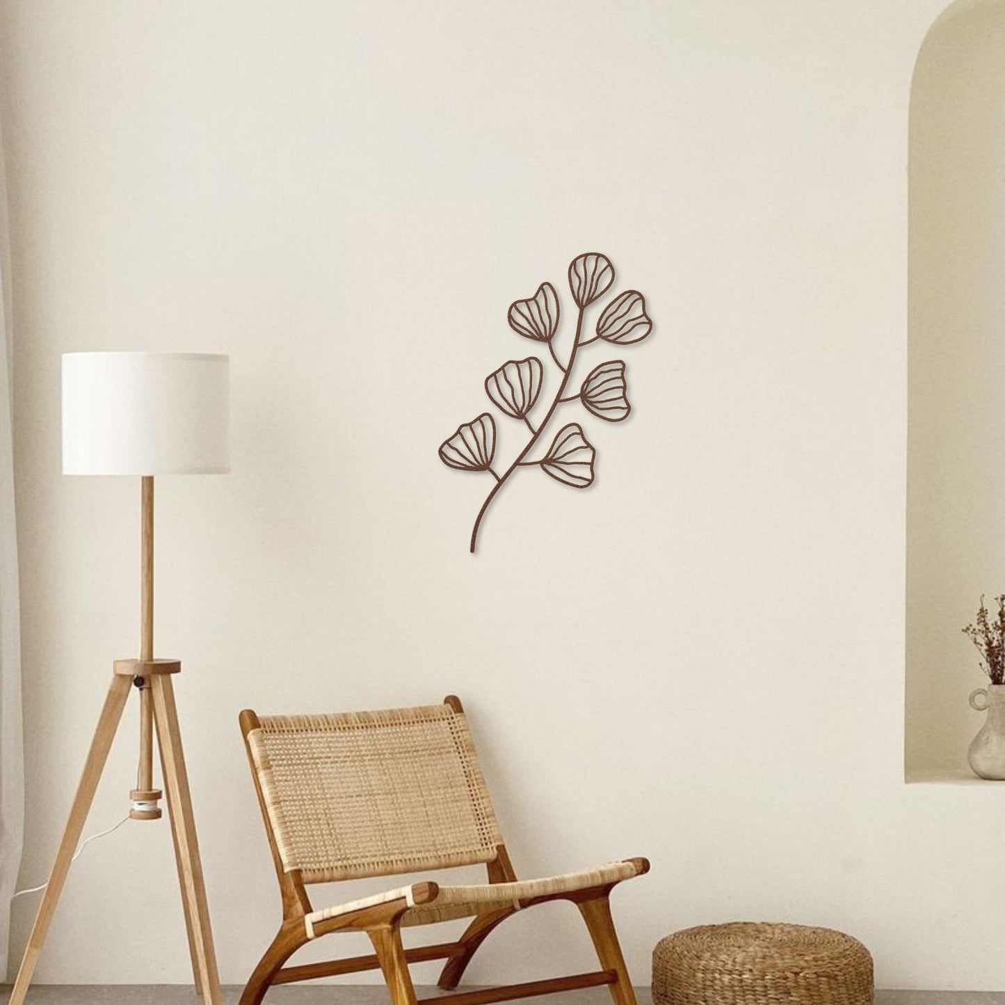 A boho-style interior with metal wall art in the shape of a leafy branch, creating a harmonious and natural vibe.