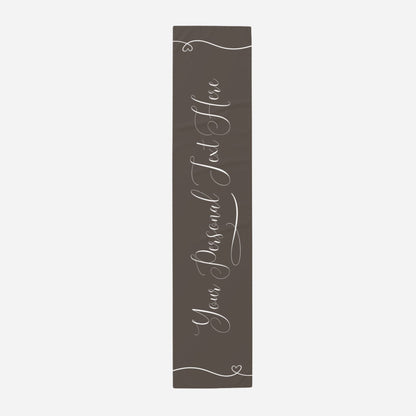 a dark brown table runner that reads "Your personal text here" in elegant script. 