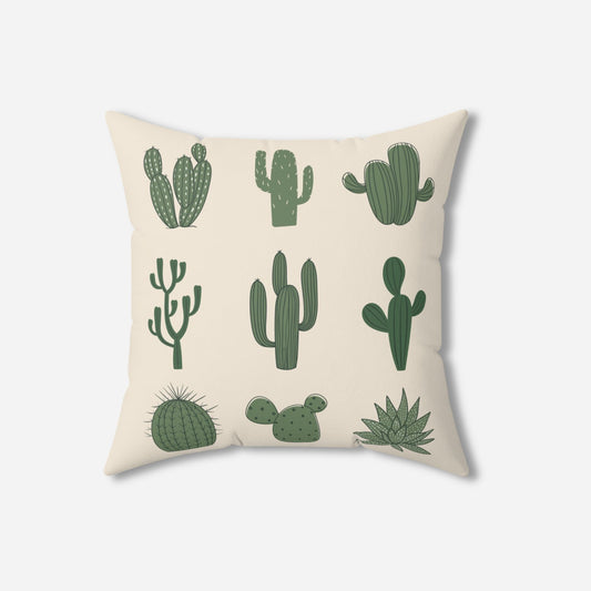 A decorative pillow with a cream background displaying various types of cactus illustrations, including saguaro, prickly pear, and barrel cacti.