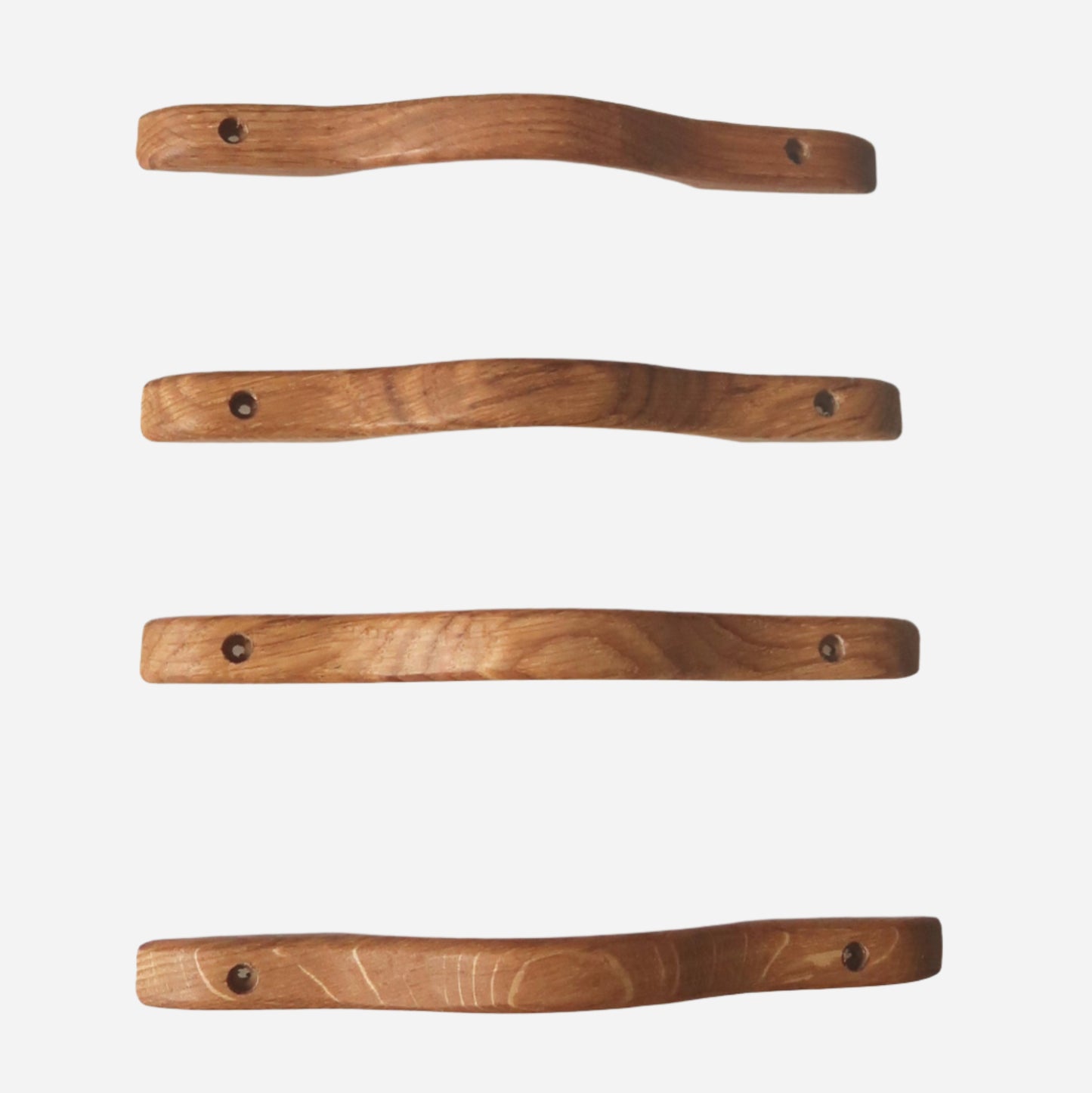 Handmade curved oak cabinet handles in natural finishes, available in two sizes