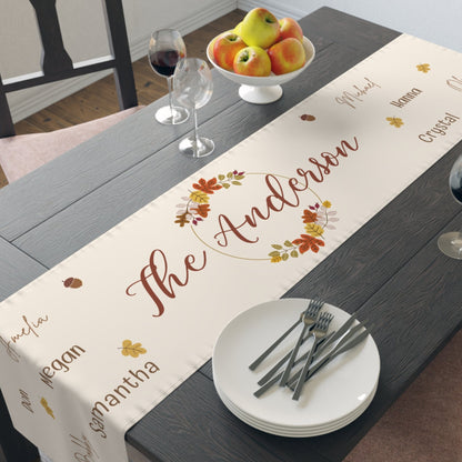 Dining table with a personalized fall-themed table runner featuring the name 'The Anderson'.