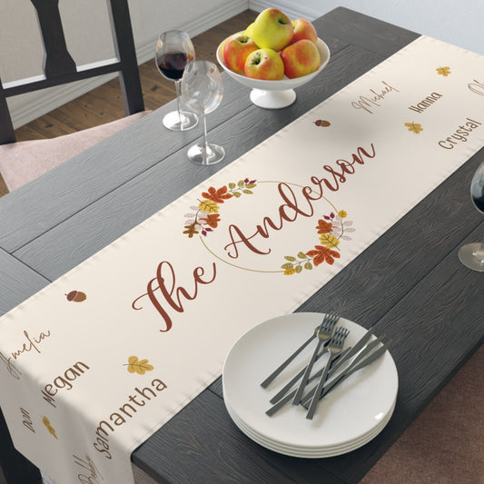 Dining table with a personalized fall-themed table runner featuring the name 'The Anderson'.
