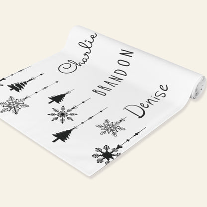 Roll of runner with names and snowflakes on a beige background