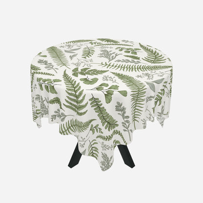 a white tablecloth that has a green fern and leaf motif