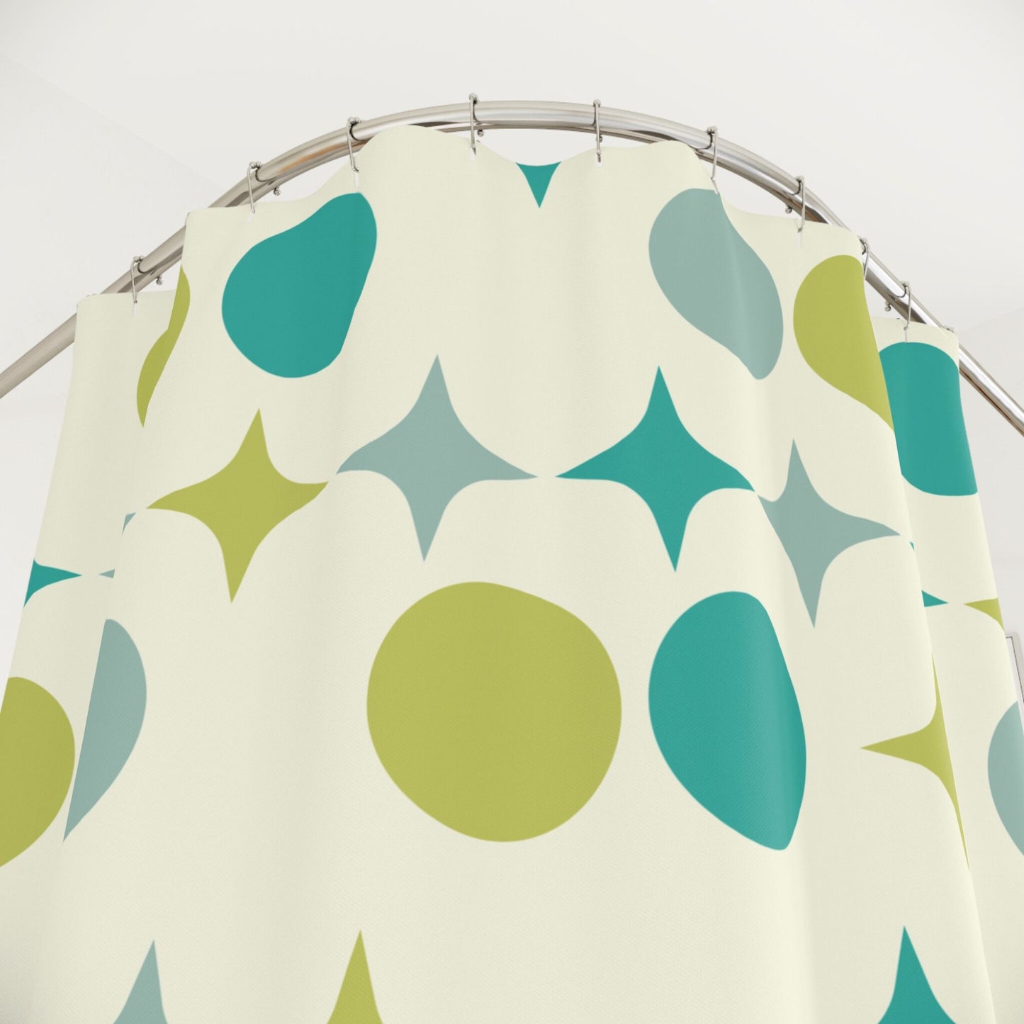 a cream shower curtain with teal and green oval and starburst 