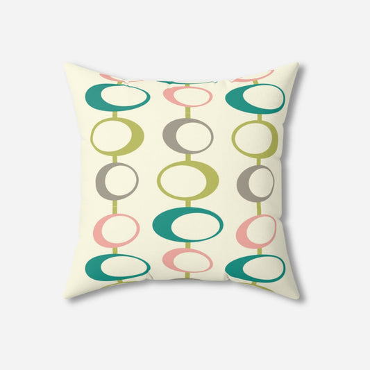 Square throw pillow with a retro design featuring vertical rows of overlapping ovals in green, teal, pink, and gray on a cream background.