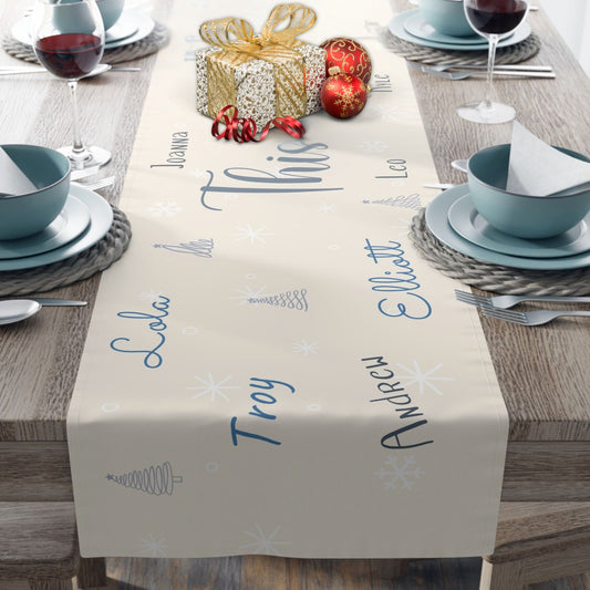 Table setting with a personalized table runner on a wooden table.