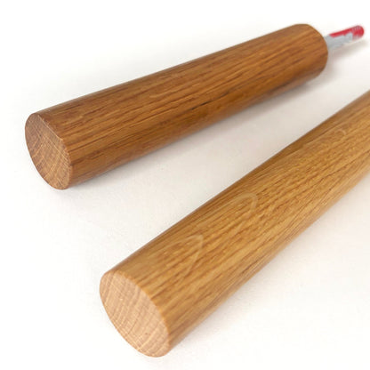 Close-up of solid oak long hooks showing wood grain and threaded mounting rod.