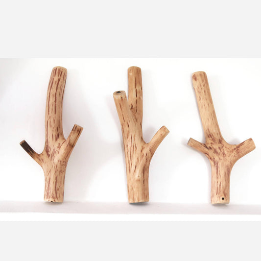 trio Handcrafted wooden hooks in the shape of a tree branch, suitable for farmhouse decor with its natural grain.