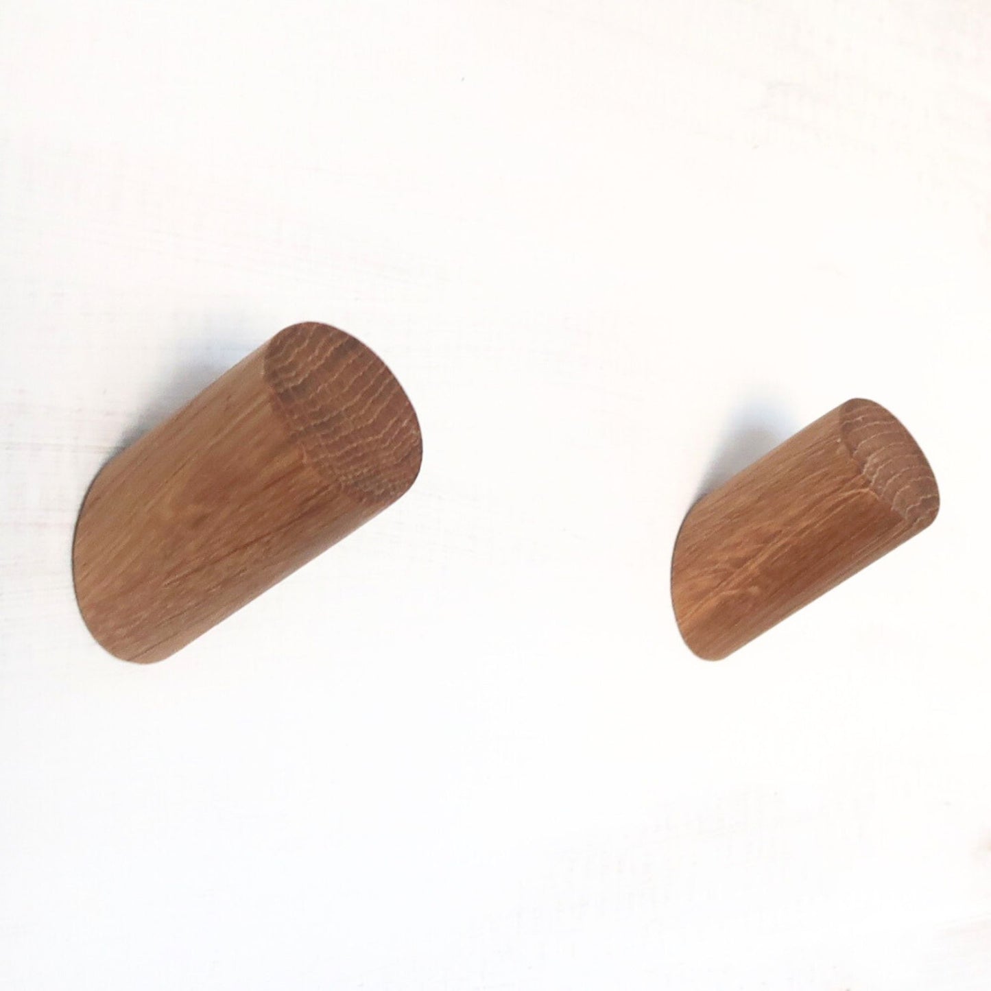 two Small oak wall hooks mounted on wall