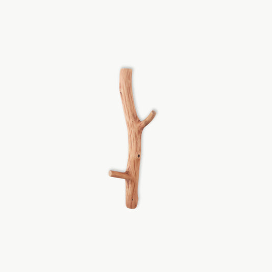 Natural oak wood wall hook with organic branch texture, minimalist home accessory.