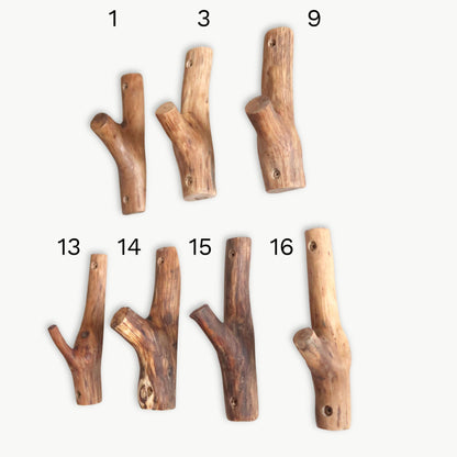 Dark oak branch wall hook with matte finish, rustic modern home decor piece.