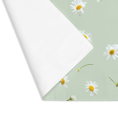 a light green placemat featuring a pattern of white daisies with white back side