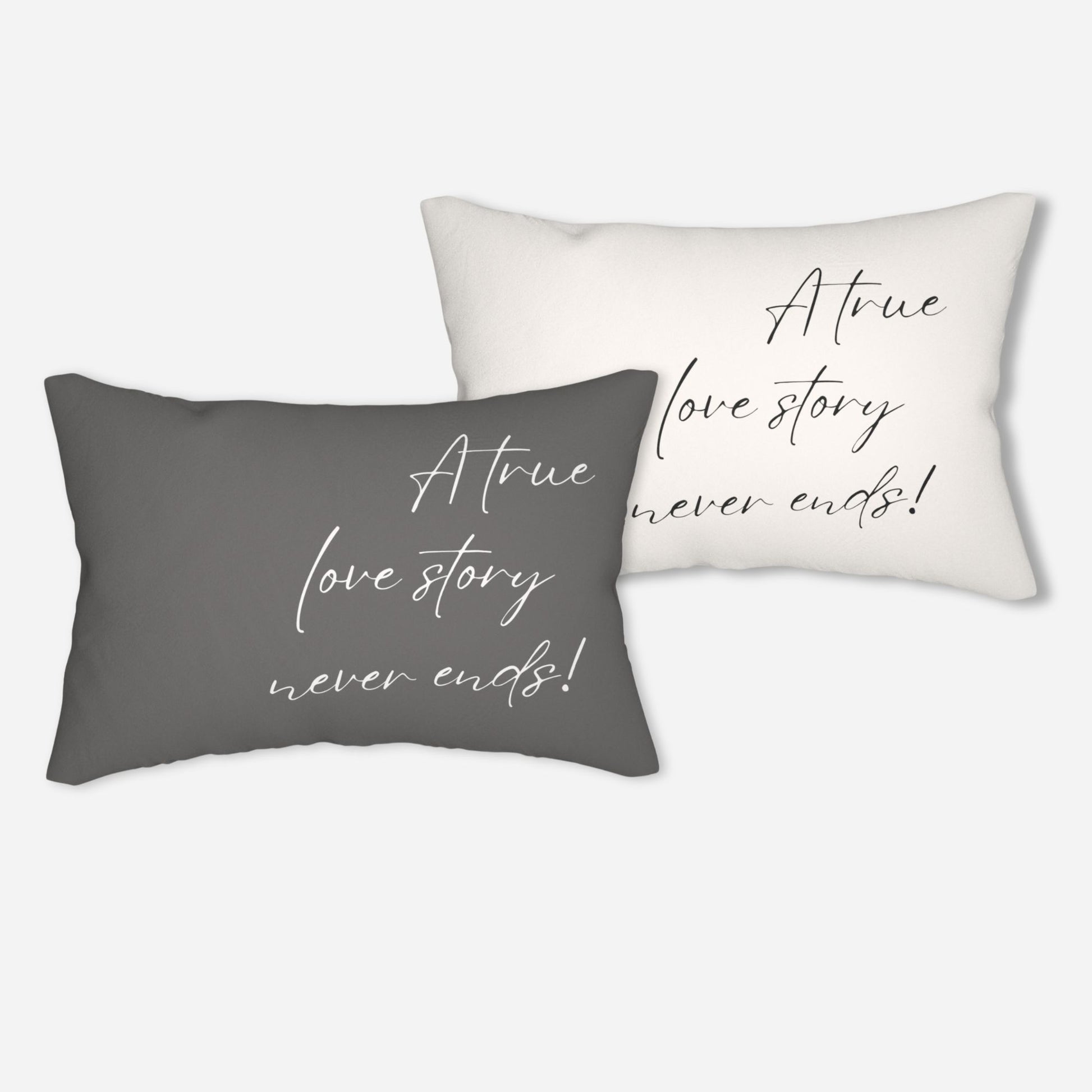 Set of two throw pillows with the inspirational message "A true love story never ends!" in stylish script, one pillow is white and the other is gray.