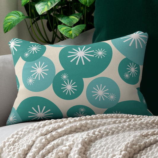 Rectangular throw pillow with a retro design featuring teal and light blue circles, each containing white starburst patterns, on a beige background.