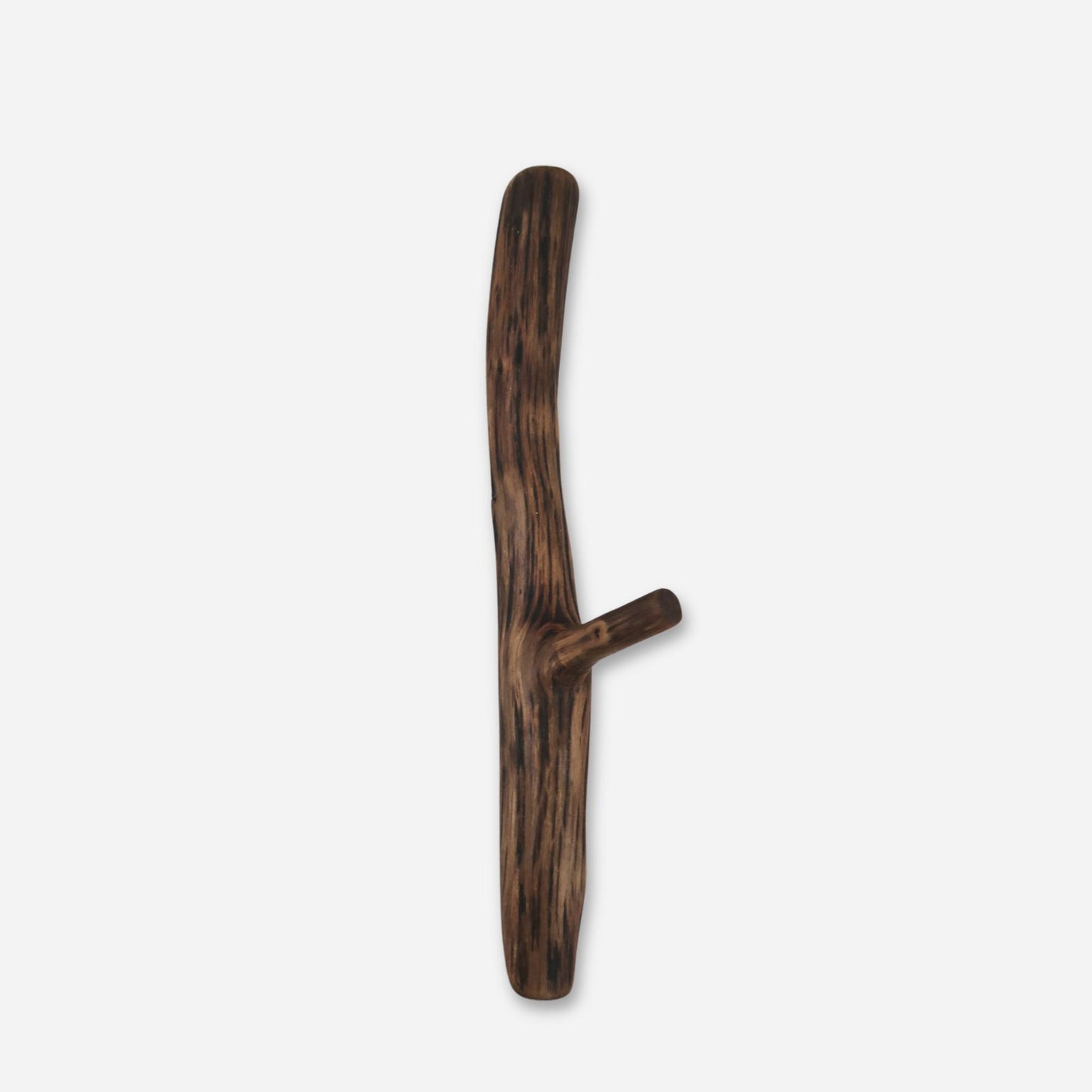 A single, branch-like oak wall hook with a dark and light wood grain texture, mounted on a white wall.