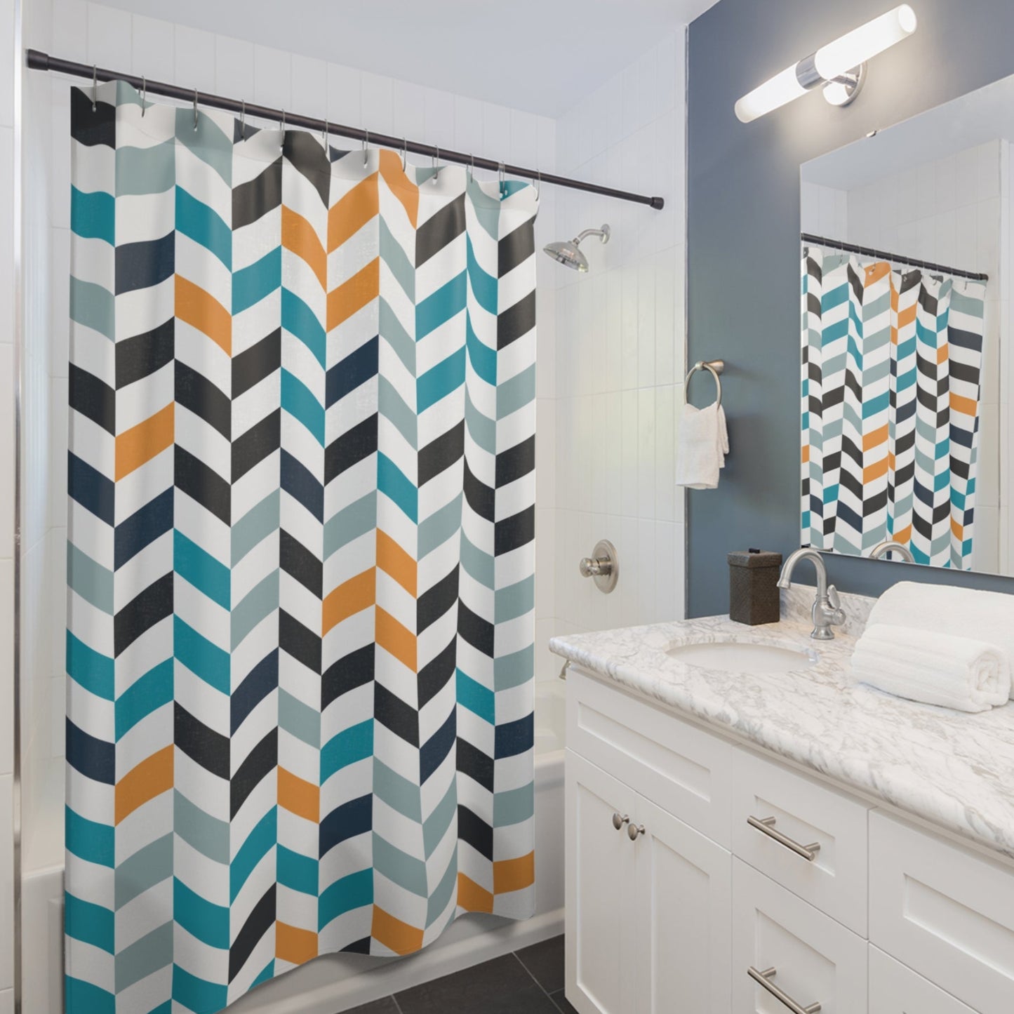 A modern bathroom with a bold chevron-patterned shower curtain in blue, orange, gray, and white. 
