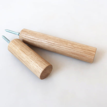 Long solid wood wall hooks in oak shown side by side