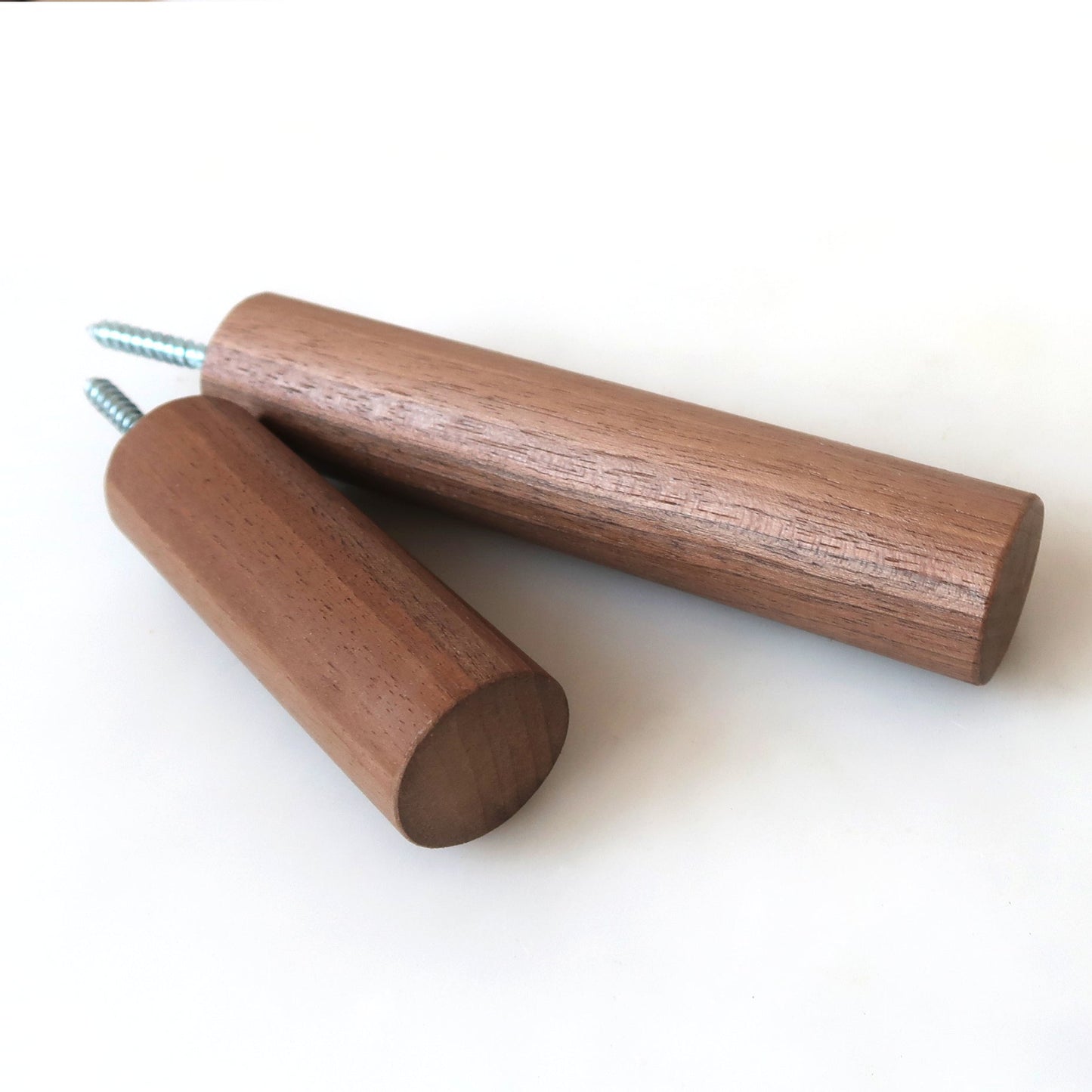 Long solid wood wall hooks in walnut shown side by side