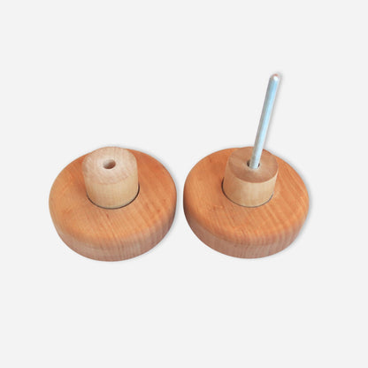 Two wooden knobs with metal shafts on a white background