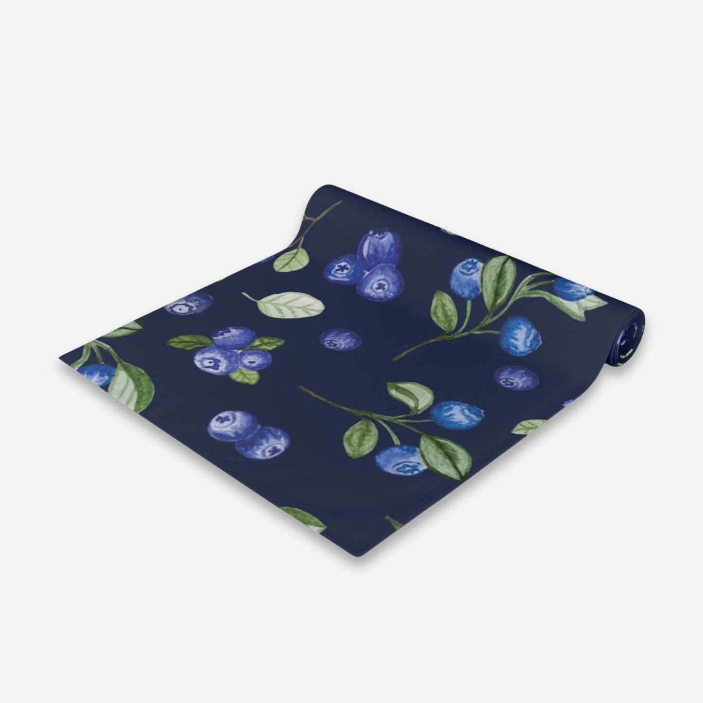 A navy blue table runner adorned with a pattern of blueberries and green leaves