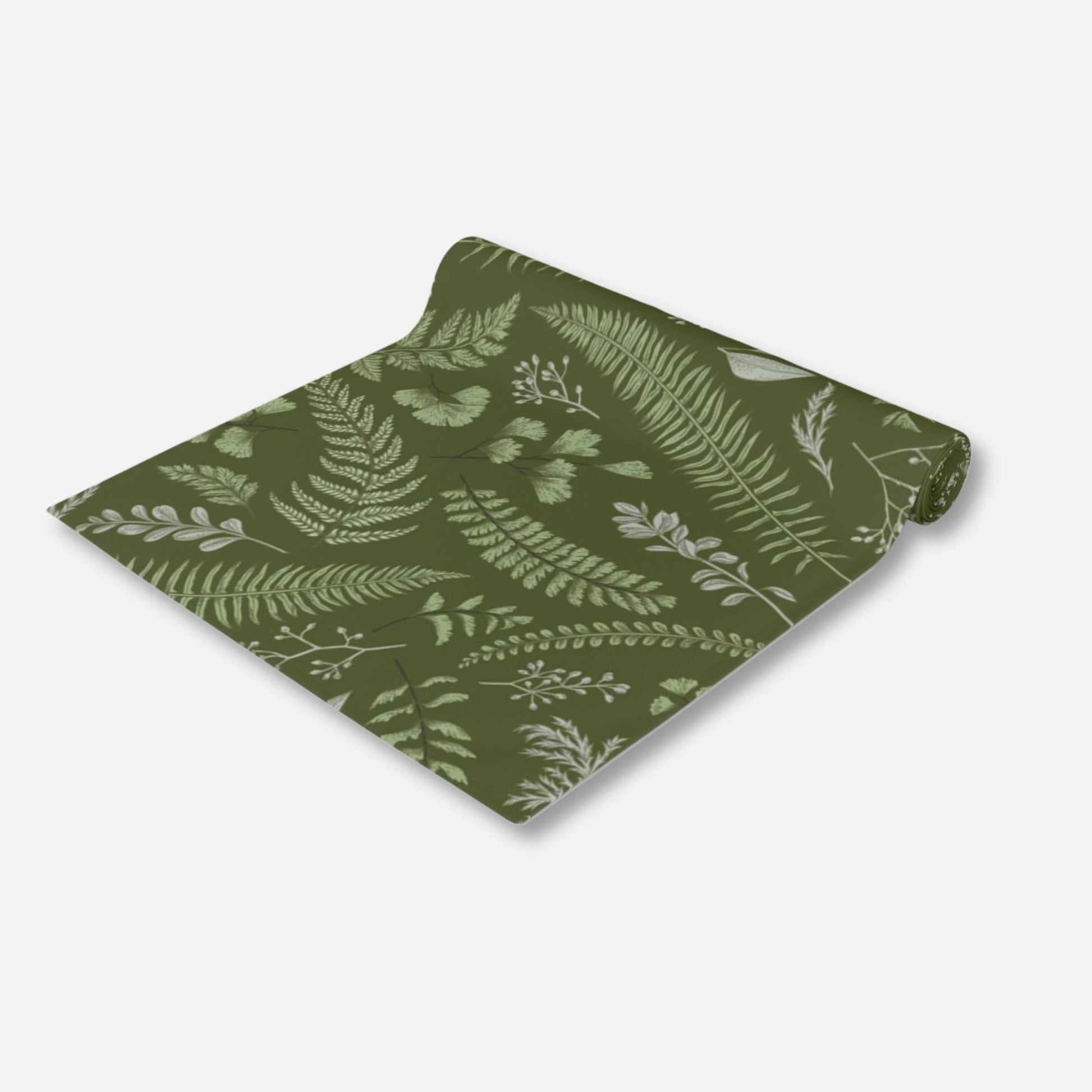 a green table runner featuring various fern leaves.