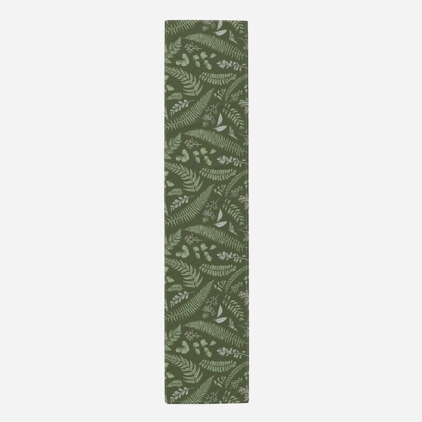 The table runner has a green background with an intricate fern and leaf pattern.