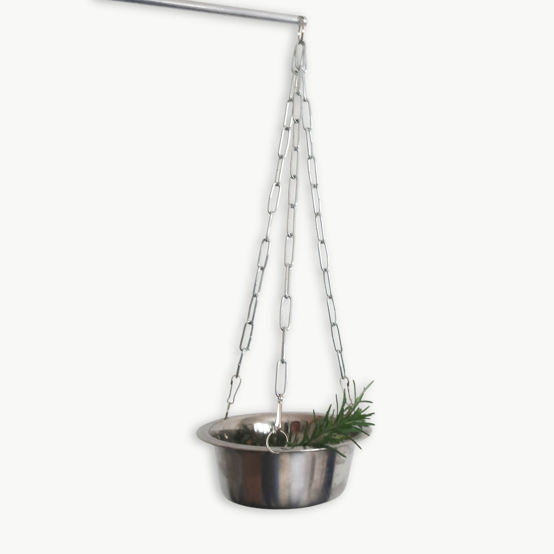 Rotating stainless steel aroma bowl hanging from chain on wall-mounted arm